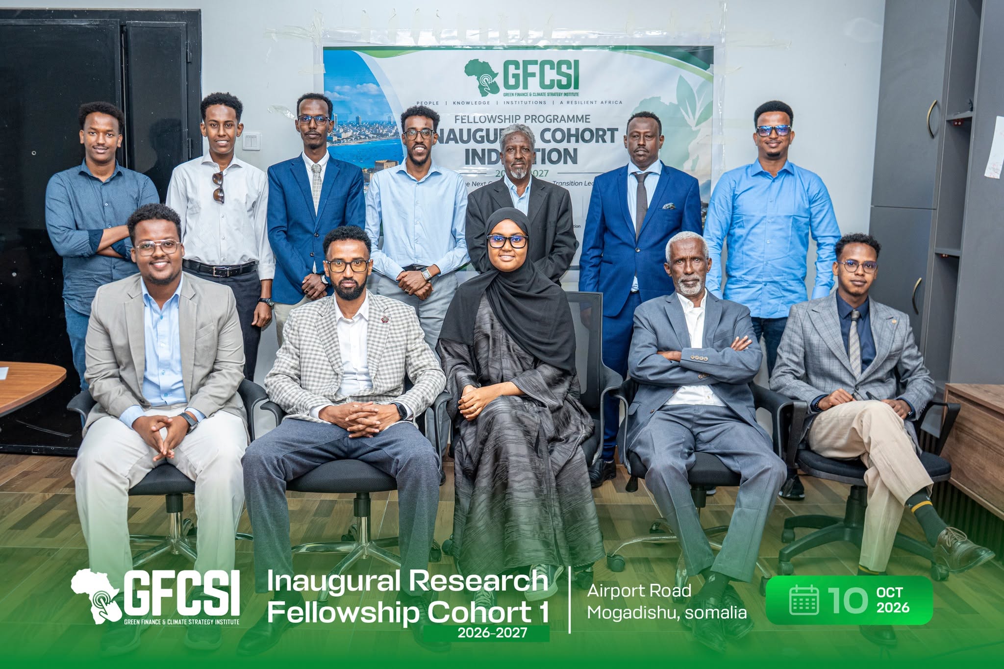 Group photograph of the inaugural GFCSI Research Fellowship cohort and GFCSI members, seated and standing in front of the induction ceremony banner in Mogadishu.